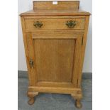 An Edwardian light oak bedside cabinet with single cock-beaded drawer and cupboard under with