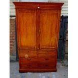 An Edwardian satin walnut linen press with moulded cornice, the reeded and panelled doors opening