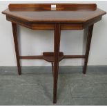 An Edwardian mahogany console table strung with satinwood and featuring batwing inlay, on tapering
