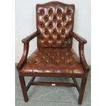 A vintage 'Gainsborough' open-sided armchair, upholstered in tobacco brown buttoned