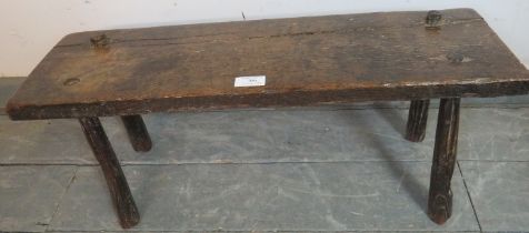 An 18th century oak country made pig bench, on canted tapering supports. Condition report: Overall