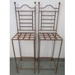 A pair of vintage outdoor wrought iron stools with ball finials and iron strapwork seats, with