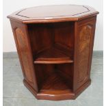 A good quality hardwood freestanding octagonal bookcase, featuring burr wood fielded panels, with