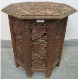 A well carved antique Anglo-Indian hardwood octagonal occasional table, the top raised on a carved