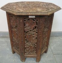 A well carved antique Anglo-Indian hardwood octagonal occasional table, the top raised on a carved