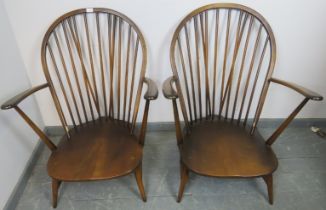A pair of vintage elm ‘Grandfather’ Windsor armchairs by Ercol (model 317) with loose seat