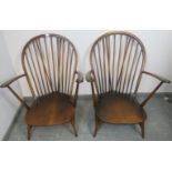 A pair of vintage elm ‘Grandfather’ Windsor armchairs by Ercol (model 317) with loose seat