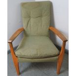 A vintage open sided beech armchair by Parker Knoll, upholstered in green material, on tapering