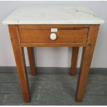 An antique stripped pine pastry table with white marble top and single drawer with ceramic knob