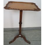 An Edwardian walnut rectangular wine table featuring gadrooned edging and carved leaf decoration, on