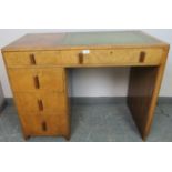 An Art Deco figured walnut kneehole desk with inset green leather tooled writing surface, housing