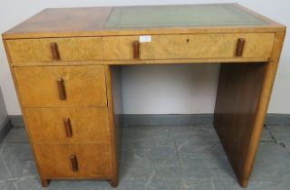 An Art Deco figured walnut kneehole desk with inset green leather tooled writing surface, housing