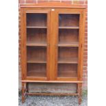 A 19th century acacia wood glazed display cabinet on stand with three fitted shelves, on spiral