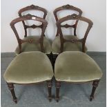 A set of four Aesthetic Period mahogany balloon back dining chairs with carved backs, upholstered in