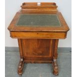 A Victorian walnut Davenport with upper gallery and inset green leather writing surface, the lid