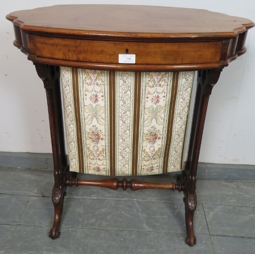 A Victorian walnut shaped sewing table with single frieze drawer and tapestry storage well under, on