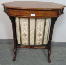 A Victorian walnut shaped sewing table with single frieze drawer and tapestry storage well under, on