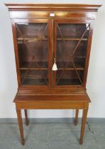 An Edwardian mahogany display cabinet on stand, strung with satinwood and featuring coromandel