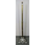 A 19th century telescopic brass standard lamp, on a very ornate cast metal tripod base with scrolled
