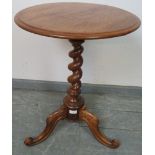 A Victorian walnut circular wine table, on barley twist pedestal with acanthus carved and scrolled