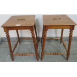 A pair of antique walnut Continental farmhouse stools, with pierced seats, on turned supports united