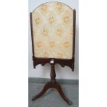 A William IV mahogany fire screen with spiral carved uprights and embroidered silk-work panel, on