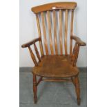 A 19th century country made elm and beech Windsor armchair, on turned supports with an ‘H’