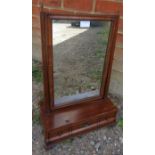 A Georgian oak and walnut swing vanity mirror with brass finials, on a box base with single drawer