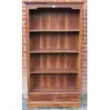 A contemporary hardwood tall bookcase of three open shelves and two short drawers under, on a plinth