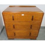 An Art Deco golden oak chest of small proportions, with three long graduated drawers, featuring