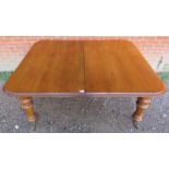 A good quality 19th century medium oak wind-out extending dining table, with two additional