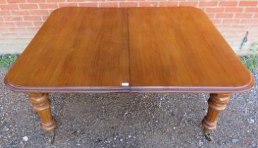 A good quality 19th century medium oak wind-out extending dining table, with two additional