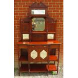 An Edwardian walnut parlour display cabinet with broken pediment and finials, sectioned bevelled