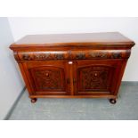 An Art Nouveau mahogany sideboard, the two short drawers with ornately cast handles and relief