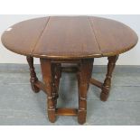 A diminutive oak oval gate leg occasional table in the 18th century taste, on turned and block