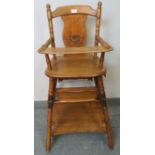 A continental beech and elm metamorphic child’s highchair, with painted backrest, on faux bamboo