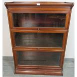 A vintage mahogany Globe-Wernicke style glazed stacking bookcase, of three sections, on a plinth