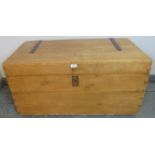 An antique stripped pine flat top trunk/blanket box with cast iron strapwork hinges and handles to