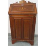 A small Edwardian mahogany marquetry inlaid bureau, with fitted interior and cupboard under with two