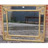 A 19th century style cushion mirror with bevelled rectangular plate in a gilt gesso fretwork