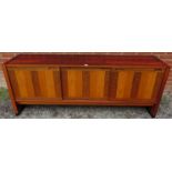 A mid-century tropical hardwood Danish sideboard featuring inlaid specimen woods, the three