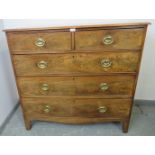 A Georgian walnut chest of two short over three long graduated cock-beaded drawers with pressed