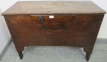 A late 17th/early 18th century joined oak coffer, with internal candle box, on stile supports.