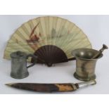 An antique hand painted fan, a Kukri knife with alloy handle, a bronze pestle and mortar and an