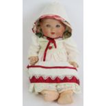 A Bisque headed Armande Marseille baby doll marked AM Germany 351/5k. Cotton and ribbon gown and