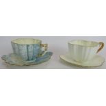 A Foley China Wileman & Co aesthetic movement cup and saucer in blue and a similar white cup and