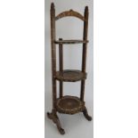 A vintage Eastern folding cake stand with bone inlay to the frame and three octagonal trays. Overall