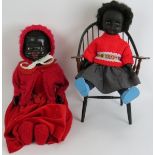 A vintage 1950s pedigree black doll with red dress and bonnet and a 1970s 'Roddy' black plastic doll
