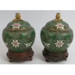 A pair of high quality Chinese cloisonné enamel covered jars on stands of raised wire floral and