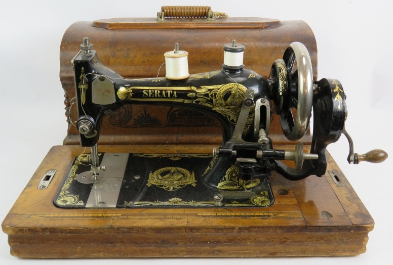 A vintage Serata manual sewing machine with wooden case, key and instructions. Condition report: